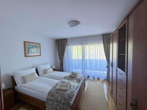 a bedroom with a large bed and a window at Lake View in Fužine