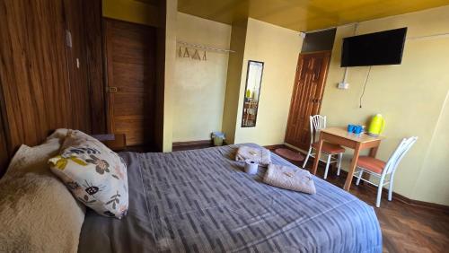 a bedroom with a bed with a teddy bear on it at Hostal La Casa del Sol in Juliaca