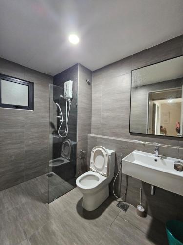 a bathroom with a toilet and a sink and a shower at Maru Maya Bay Guest House in Banting