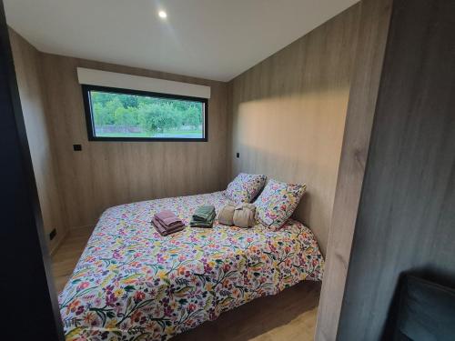 a bedroom with a bed with two bags on it at TREE LODGY - LE CHARME - Nouveau espace bien être disponible in Ray-sur-Saône