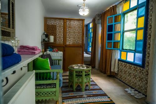 a room with a table and some windows at Dar El Rezk in Tunis