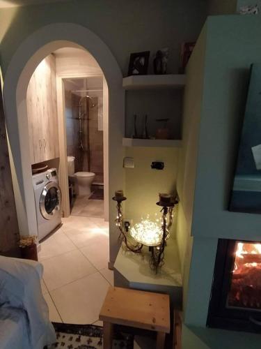 a room with a bathroom with a washer and dryer at To Fournaraki in Gialiskari