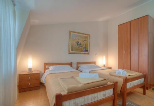 a bedroom with two beds and two night stands at Pansion 22 CETINJE in Cetinje