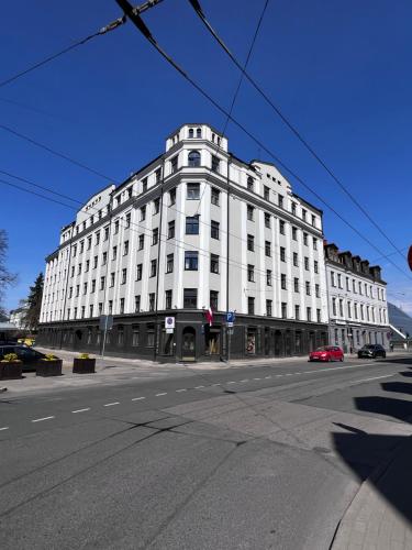 a large white building on the corner of a street at GREEN Apartment in Riga