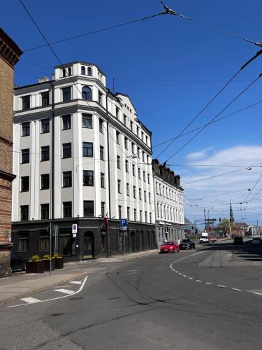 a white building on the corner of a street at GREEN Apartment in Riga