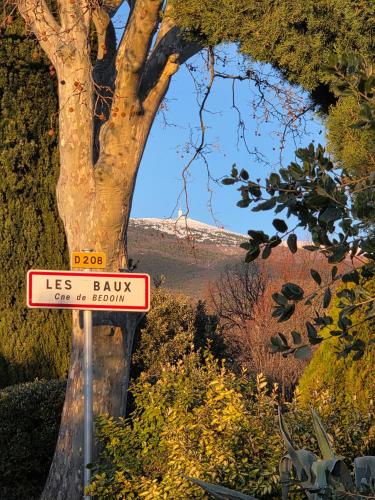 a sign in front of a tree in a garden at Les Gites du Mont Ventoux in Bédoin