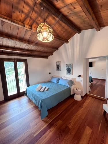 a bedroom with a bed and a wooden ceiling at RossoScirì in Calatafimi