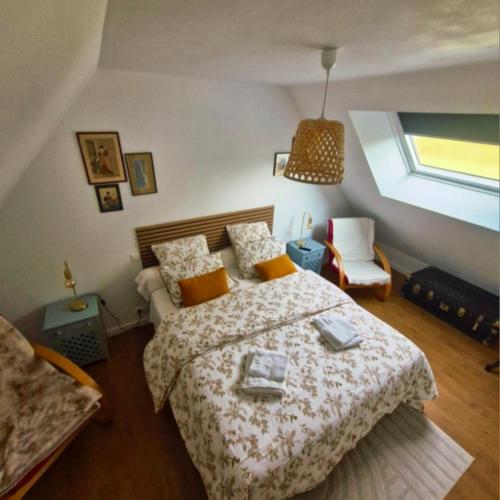 a bedroom with a large bed and a window at la guichardaye in Tréal