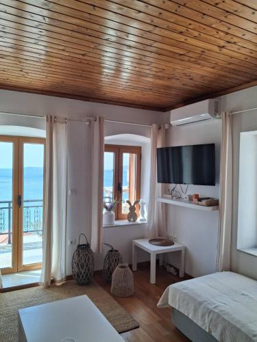 a bedroom with a bed and a view of the ocean at Seaview studio in Neapoli Voion