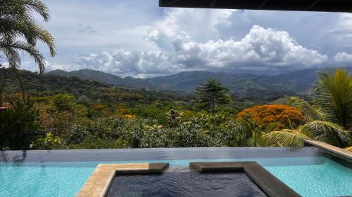 a swimming pool with a view of the mountains at Luxury In The Jungle in Barú