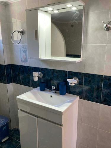 a bathroom with a white sink and a mirror at Melinda Tower in Plomari