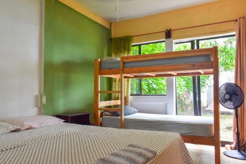 a bedroom with two bunk beds and a window at Guesthouse Island Escape in Corn Islands