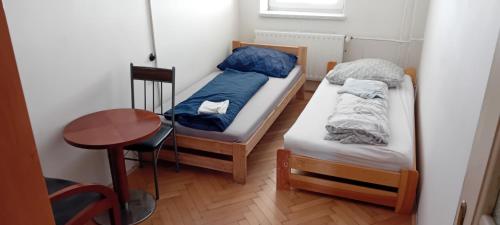 a small room with two beds and a table at Vilem in Komárov