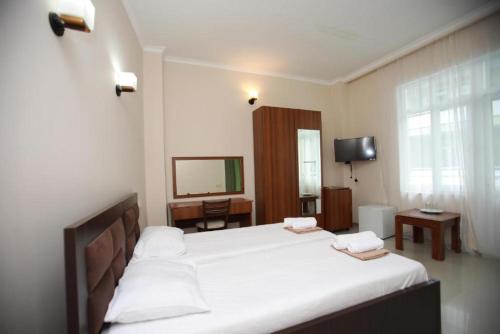 a hotel room with two beds and a television at Green House Hotel N2 in Kobuleti