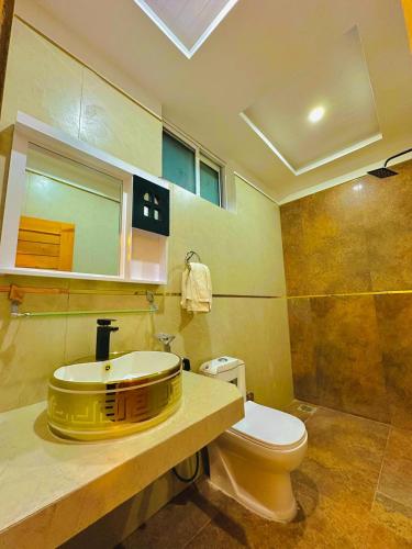 a bathroom with a yellow sink and a toilet at Pine Peaks Heaven in Nathia Gali
