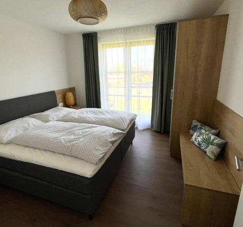 a bedroom with a bed and a large window at Haus Gruber in Attersee am Attersee