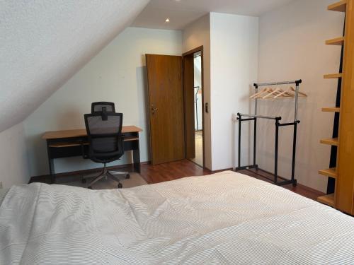 a bedroom with a bed and a desk and a chair at Burato`s Haus in Minden