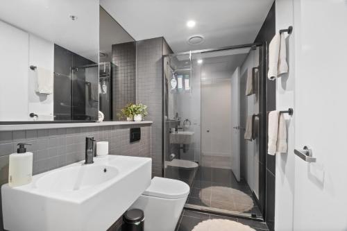 a bathroom with a sink and a toilet at Premium 2BR Braddon, Marriott Amenities in Braddon
