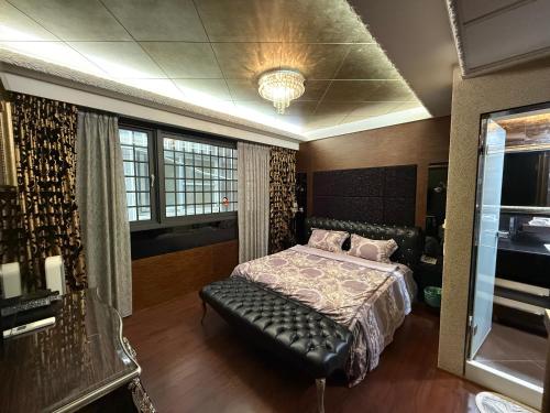 a bedroom with a bed and a bench in it at 木木 Lin in Chiayi City