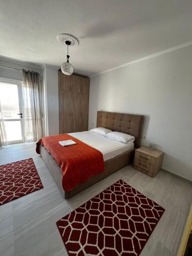 a bedroom with a bed and a red blanket at InnPogradec Center in Pogradec