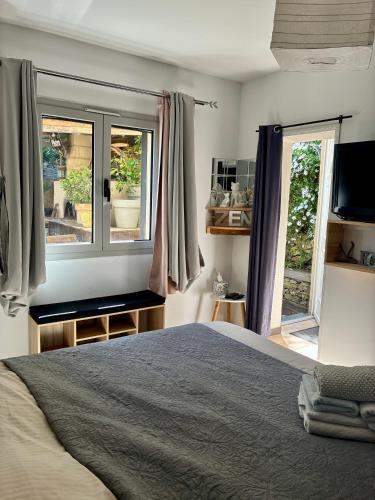 a bedroom with a bed and two windows at U Sognu in Muro