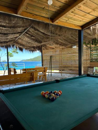 a pool table with balls on top of it at Oasis on the Beach in Himare