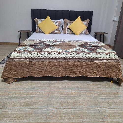 a bedroom with a large bed with yellow pillows at Oasis Mountain Retreat in Le Morne