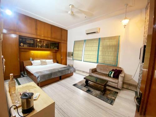 a hotel room with a bed and a couch at Chinar Homes Amritsar in Amritsar