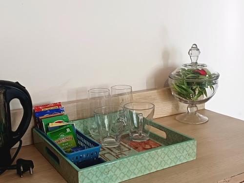 a tray with glasses and a bowl on a table at Chinar Homes Amritsar in Amritsar