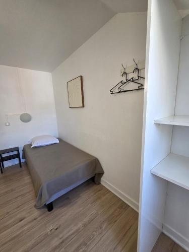 a small bedroom with a bed in a room at Budget Hôtel Weber - Strasbourg Centre Gare in Strasbourg