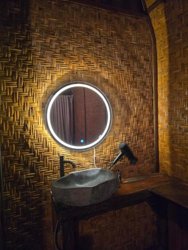 a bathroom with a stone sink and a mirror at Lombok Rice Terracce Glamping in Tetebatu
