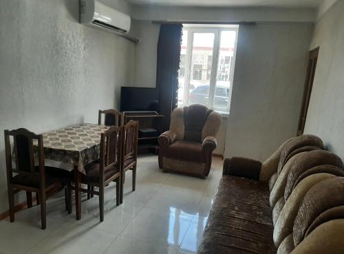 a living room with a couch and a table and chairs at Hotel MANTASHOV in Meghri