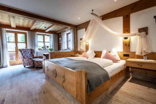 a bedroom with a large bed with a canopy at Das Landhaus in Pfronten