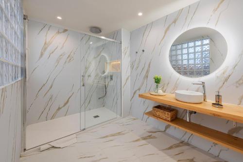a bathroom with a sink and a mirror at Apartment VistaMar I in Port de Pollensa