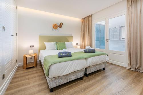 a bedroom with a large bed and a window at Apartment VistaMar I in Port de Pollensa