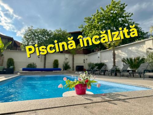 a villa with a pool and a sign that reads piscina incasia at Kaleh Boutique Villa in Orşova