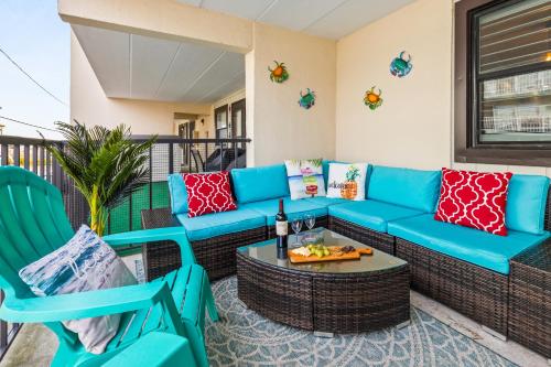 a patio with a blue couch and chairs on a balcony at Late August Labor Day Deals! Ocean Block Sleeps 6 Beach Gear in Ocean City