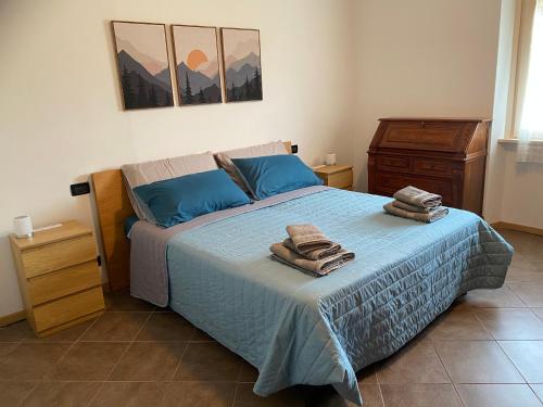a bedroom with a bed with towels on it at Il Respiro del Brenta in San Lorenzo in Banale