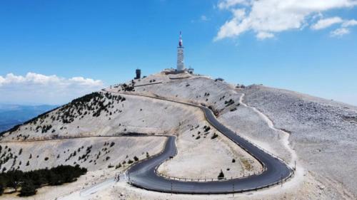 a winding road on top of a mountain with a lighthouse at Hôtel et SPA des sources du gros noyer in Malaucène