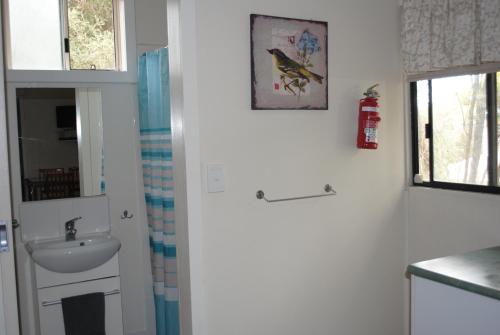 a bathroom with a sink and a toilet and a window at Padthaway Caravan Park in Padthaway