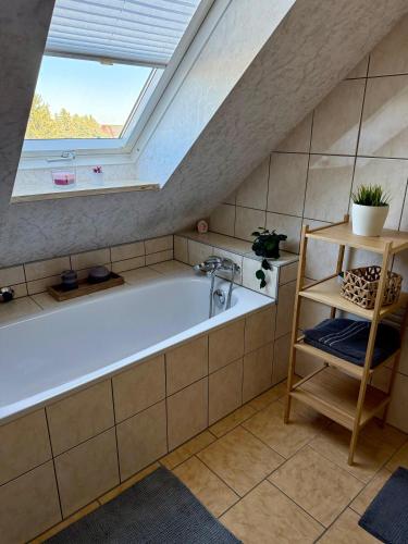 a bathroom with a bath tub with a window at Ferienwohnung Carla in Weißensee