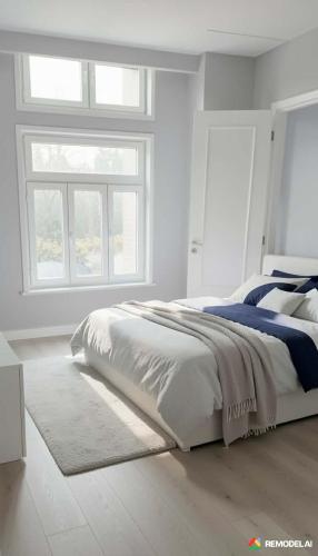 a white bedroom with a bed and a window at Mary Mary! in Agios Kirykos