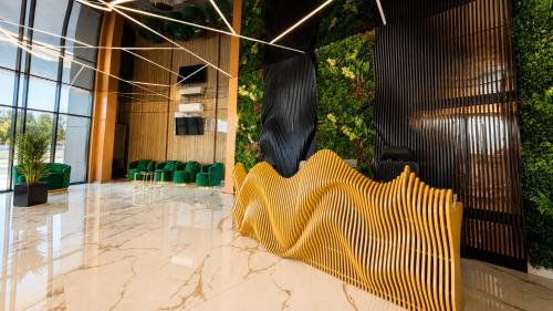 a lobby with a yellow sculpture on the floor at Office Villas Costinesti in Costinesti