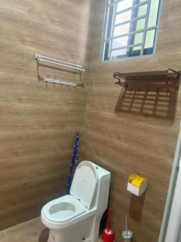 a bathroom with a white toilet and a table at Nadyapartment in Dodoma
