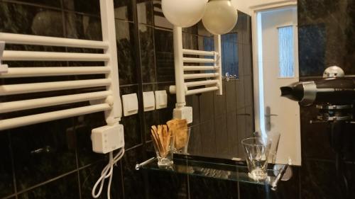 a bathroom with a glass counter and a mirror at u Bozeny pokoje in Dźwirzyno