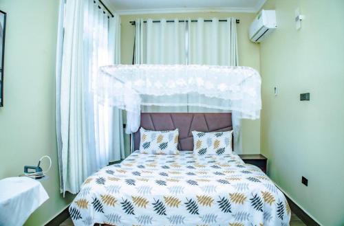a bedroom with a large bed with a canopy at Nadyapartment in Dodoma