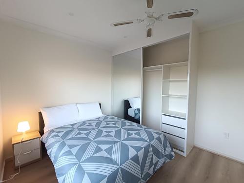 a bedroom with a large bed and a closet at Spacious and Comfortable Queen Room - NM1 in Merrylands