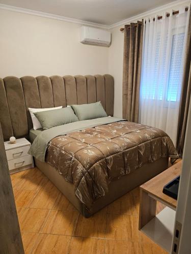 a bedroom with a large bed with a large headboard at Asea Apartaments in Golem