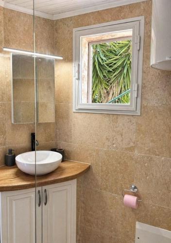 a bathroom with a sink and a window at Seaside Apartment in Conca