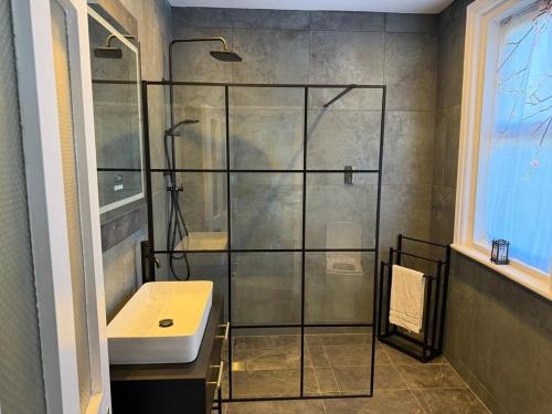 a bathroom with a shower and a sink at Exmouth Devon Luxurious Flat OverlookingThe Sea in Exmouth